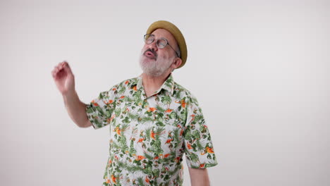 man dancing in a hawaiian shirt and hat