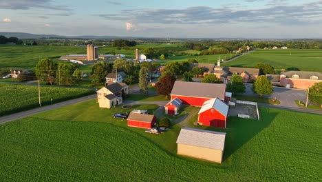 american farm with red barns and green fields