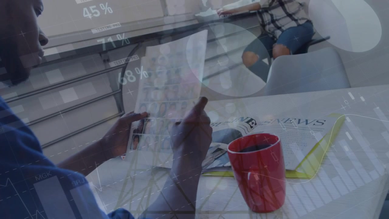 Man opening folded sheet, scanning roster at table while data overlays overlaying faces for hiring