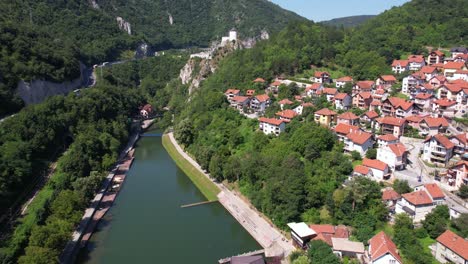 aerial view of uzice, serbia. river lakes, fortress and buildings on sunny summer day, revealing drone shot