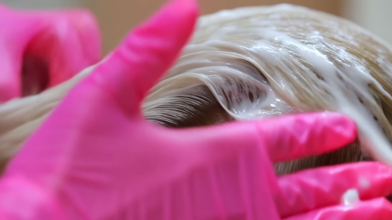 Closeup Blonde Hair Bleaching Application Salon Stylist Wearing Pink Gloves Sections Roots And Smooths Creamy