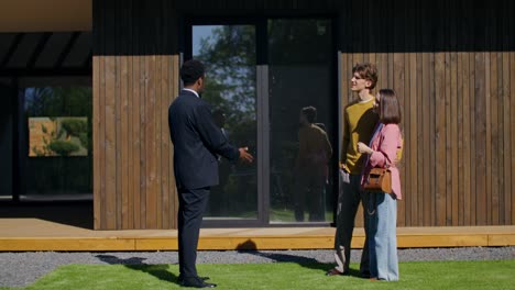 real estate agent showing a modern home to a couple
