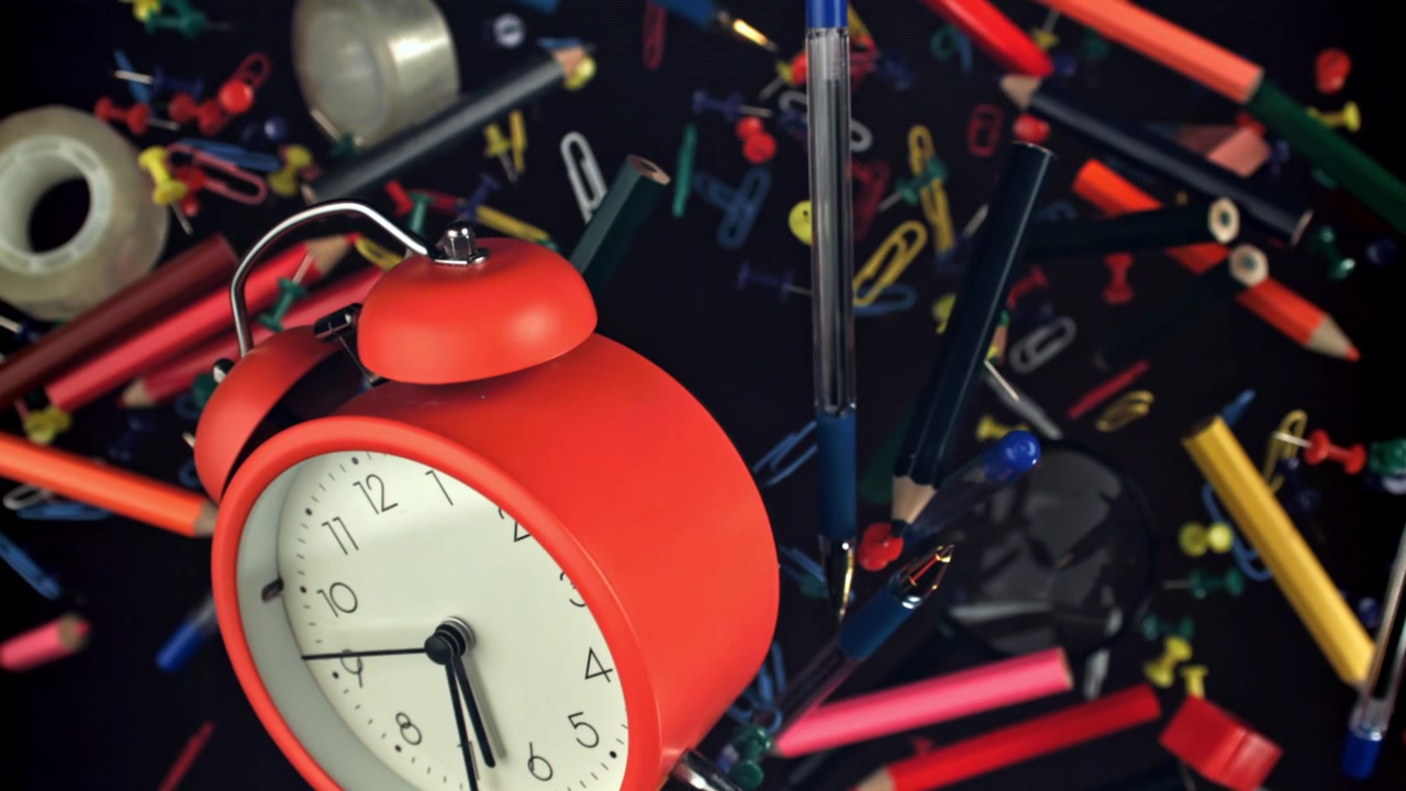 Red Alarm Clock and Floating School and Office Supplies