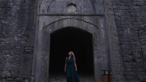 blonde woman leaving the gate of rozafa castle, albania. slow motion