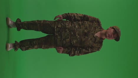 full body of asian male soldier standing and looking around with serious facial expression to protects his country from the war on the green screen background