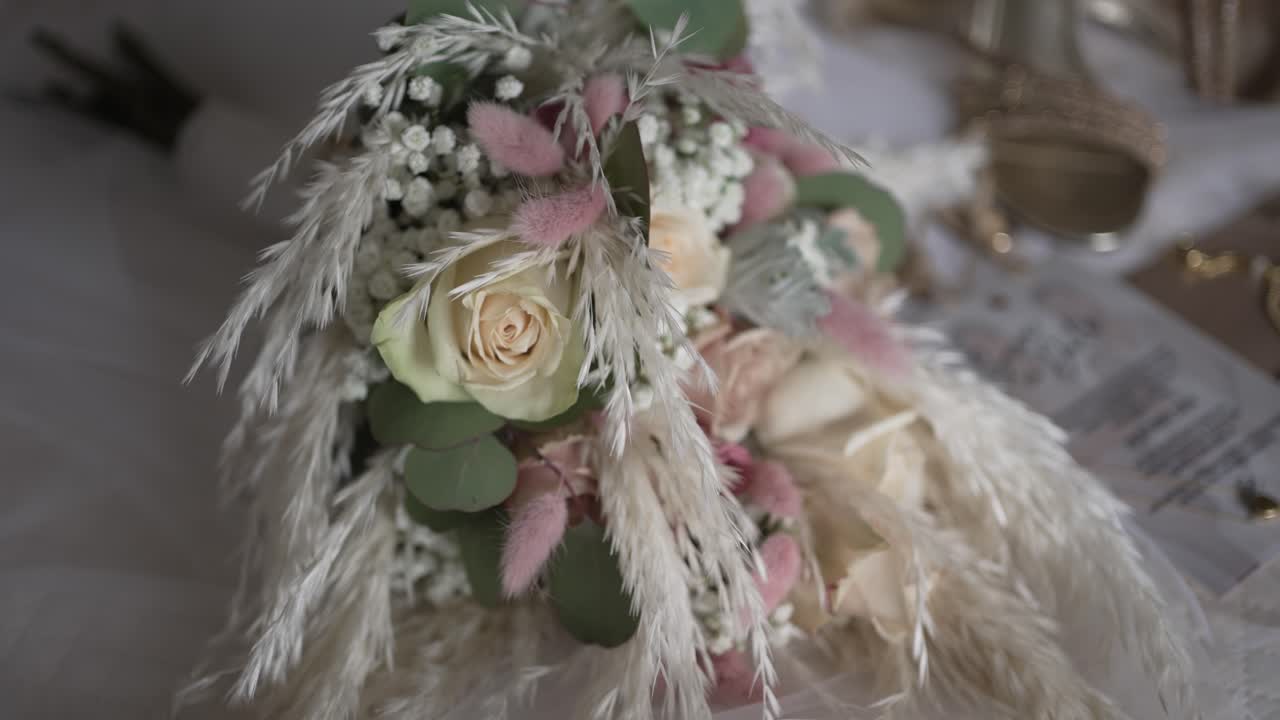 Delicate bouquet with dried flowers, roses, and greenery for a vintage-inspired wedding