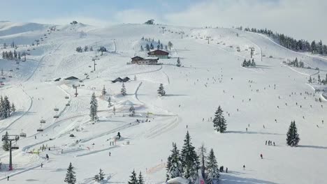 drone ski slope snowy mountain with people