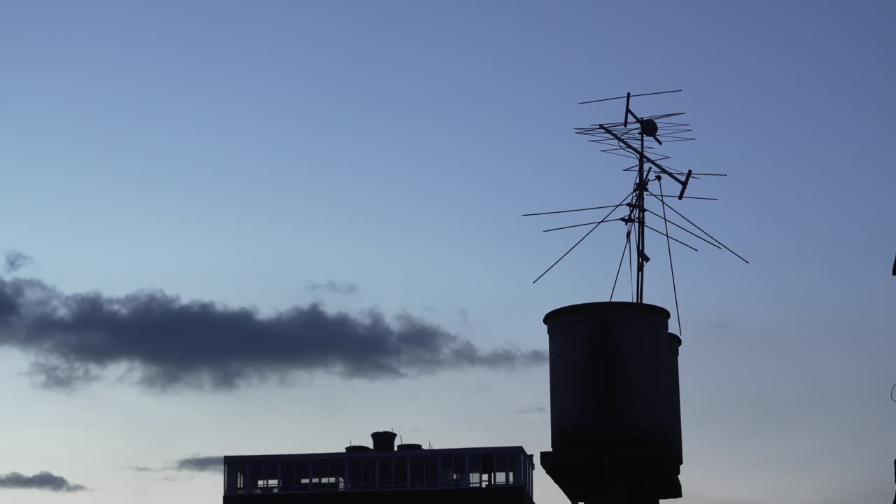 Rooftop television antenna Bogotá Colombia residential building agiangs cloudy blue skyline