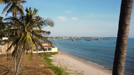 Revealing-a-whale-temple-in-Vietnam,-a-fishing-harbour-in-the-background-with-hundreds-of-boats