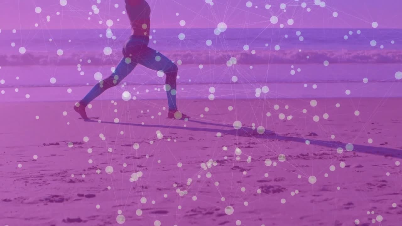 Yoga practitioner stepping onto sandy shore with waves entering high lunge at sunrise for fitness