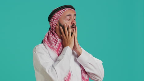 middle eastern guy deals with migraine