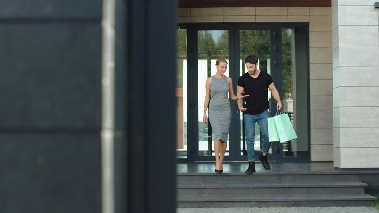 ⁇ 만적 인 부부 가 가방 을 들고 집 밖 으로 나간다. 즐거운 가족 이 손 잡고 있다