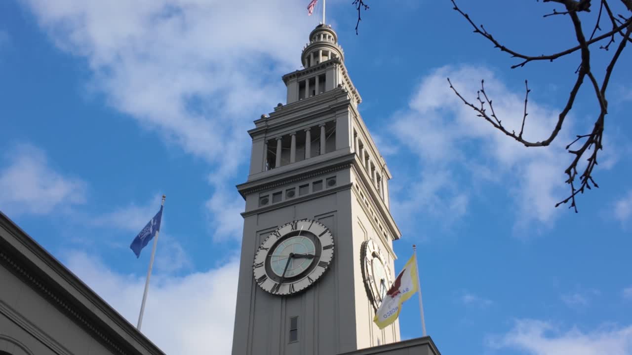 Gimbal close tilting-up shot of the Ferry Building clock tower at the Port of San Francisco in Northern California. 4K