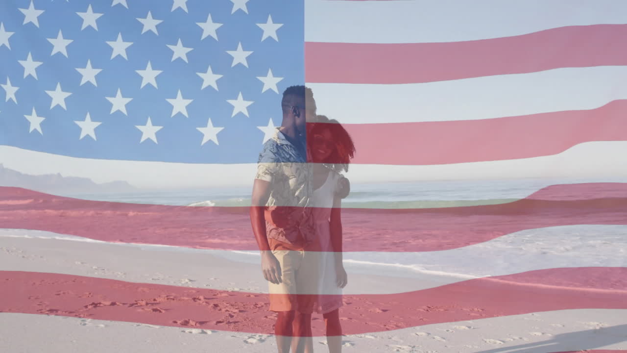 animación de la bandera estadounidense sobre una pareja de pie en la playa, disfrutando de la vista