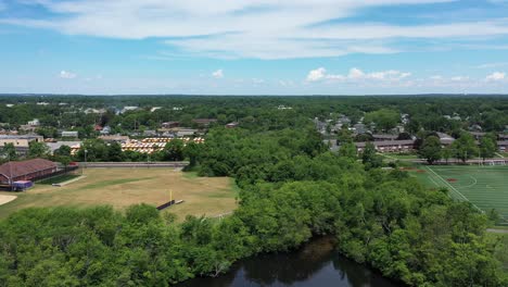 A-high-angle-shot-as-the-drone-camera-dolly-in-slowly-over-a-pond's-edge