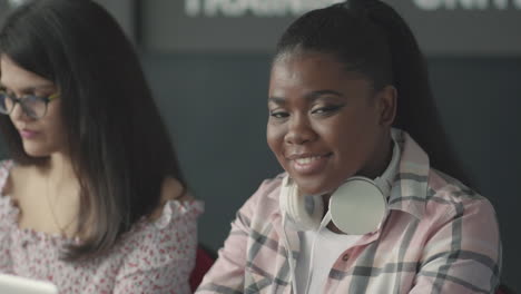 pretty black student girl looking at the camera and smiles