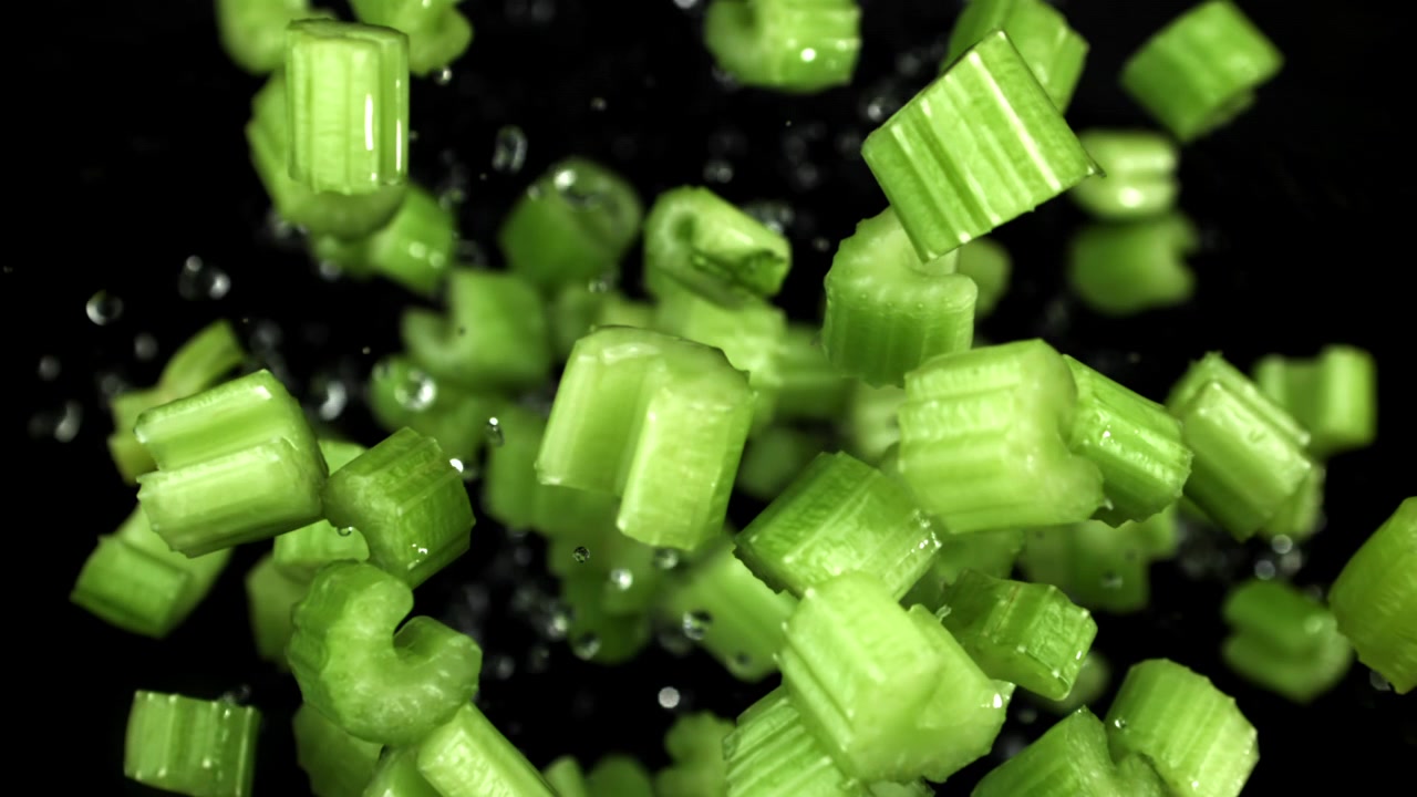 Fresh Chopped Celery Pieces Falling in Slow Motion