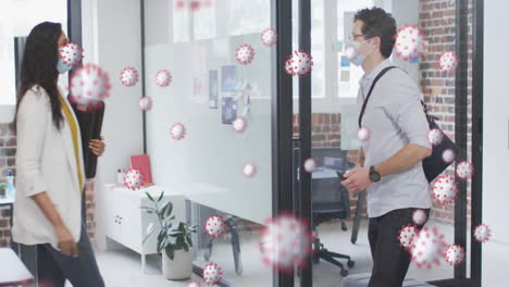 animation of covid 19 cells over man and woman in face masks in office, touching elbows