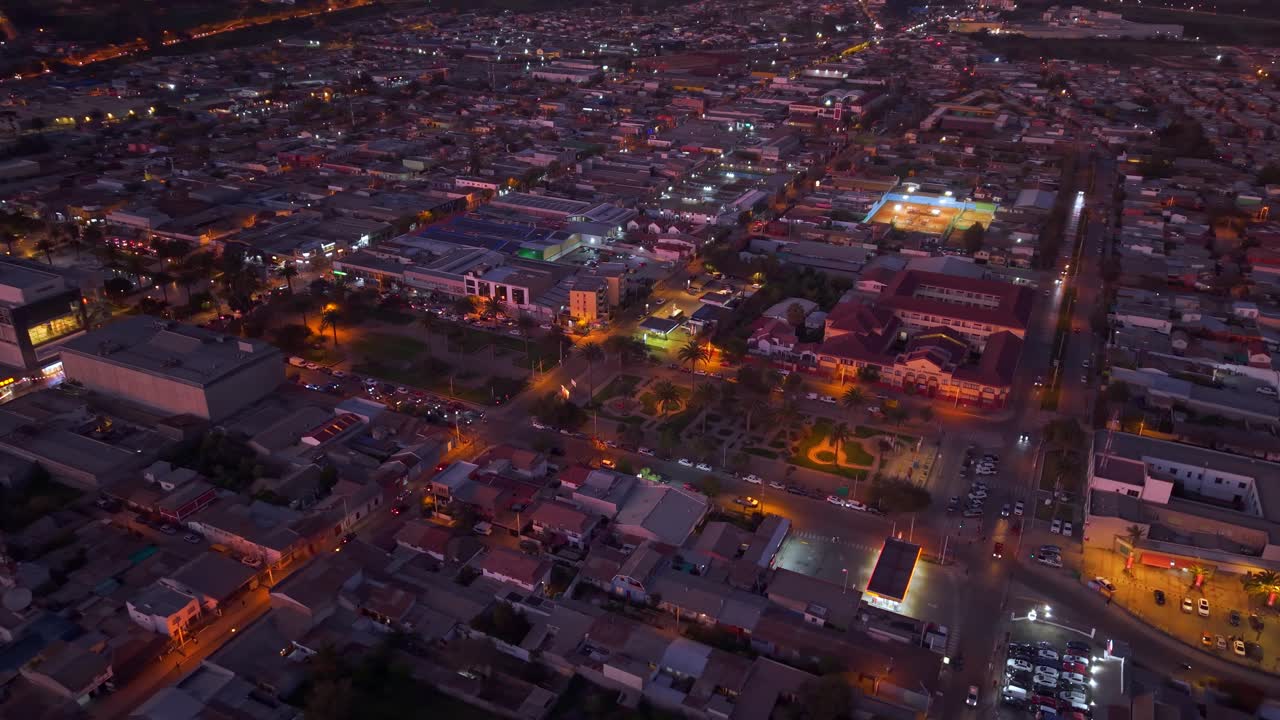 Aerial view of the city of Ovalle at night with lights and cars with lights, dim purple light, northern Chile, Limarí Valley