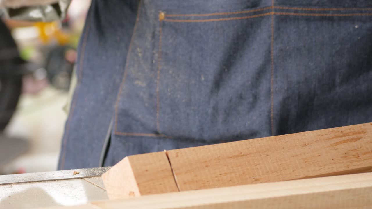 A man using Grinding machine sawing cutting wooden