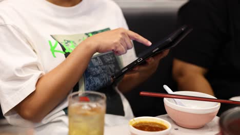 person using tablet to order food