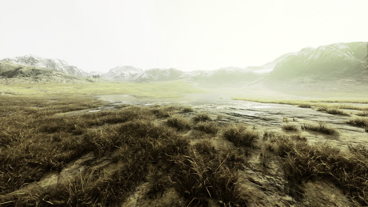 Vast landscape surrounded by mountains under a hazy sky