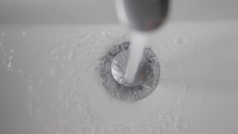 water running from faucet into sink