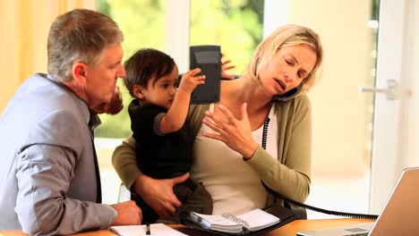 Parents-trying-to-work-at-a-desk-with-baby