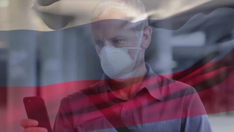 animation of flag of russia over man wearing face mask