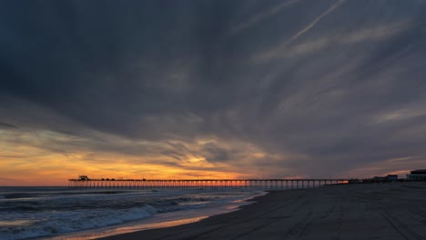 clouds on fire sunset, time lapse of clouds rolling in over the pier on the ocean, end of clip is spectacular