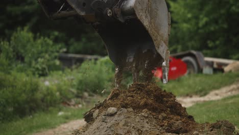 excavator dumping fesh dirt soil on working construction site