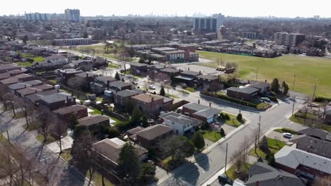 drone circling over school in sunny toronto neighborhood in spring time