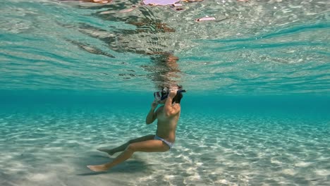 Undersea-scene-of-young-girl-having-fun-in-pristine-tropical-sea-water-of-exotic-island