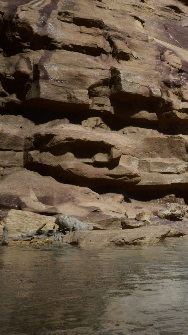 Rock formations and calm water by the river in a natural setting