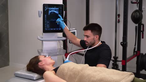 physiotherapist with patient during ultrasonography examination in clinic