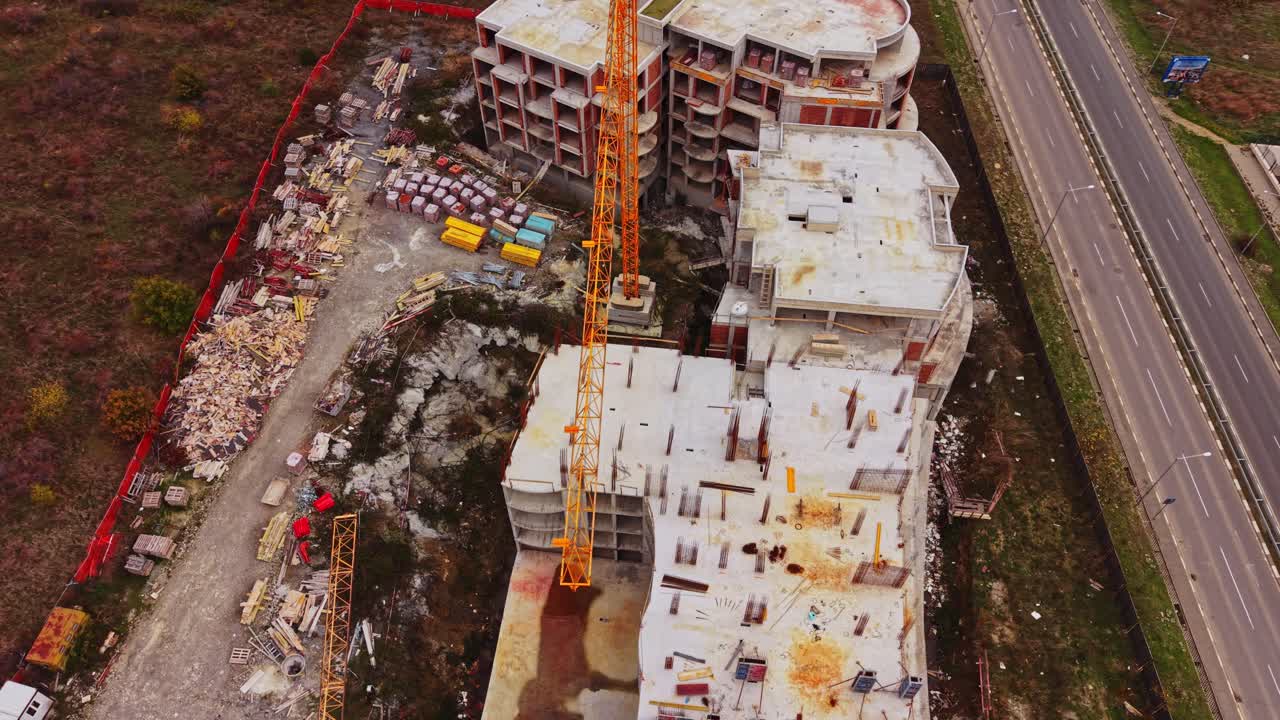 Construction site viewed from above near busy roadway