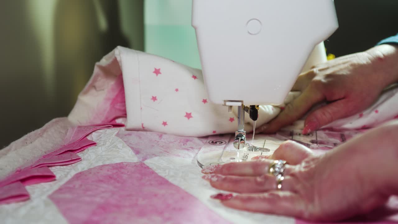 Stitching a pattern on a handmade quilt with a sewing machine fitted with a plastic template