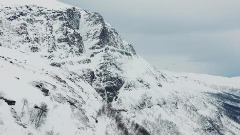 snowy rocky mountain top in northern norway alps landscape, aerial