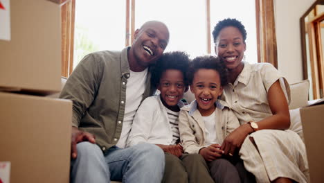 happy black family, box and sofa in new home