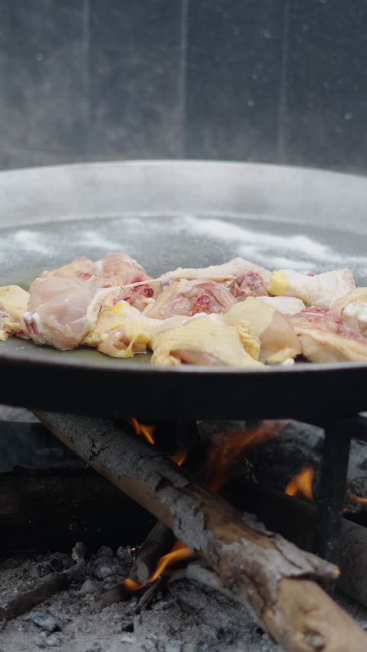 Cooking chicken over a fire