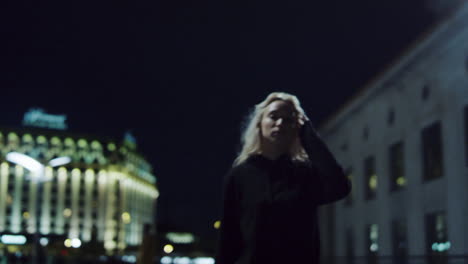 confident girl walking city at night street lights in urban background.