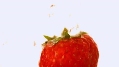 water falling on a strawberry