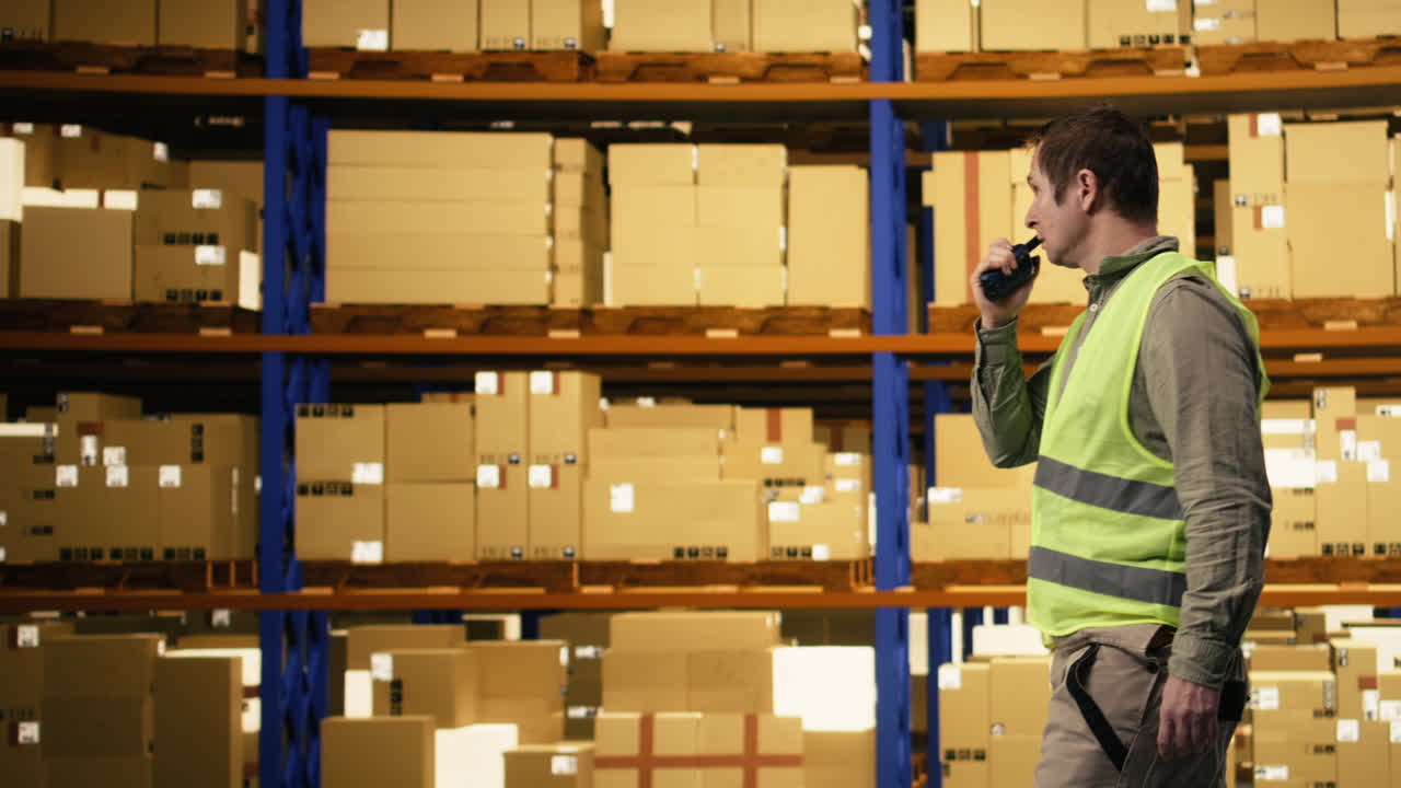 Instructions over walkie-talkie, industrial worker, for colleague to move cargo