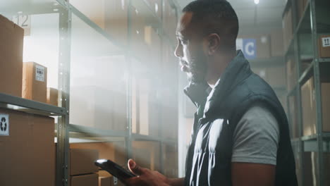 african american warehouse associate checks parcel information at terminal african american warehouse associate scans code on cardboard box with scanner checks parcel information at terminal works in delivery service digital screen shows green screen chroma key mock up