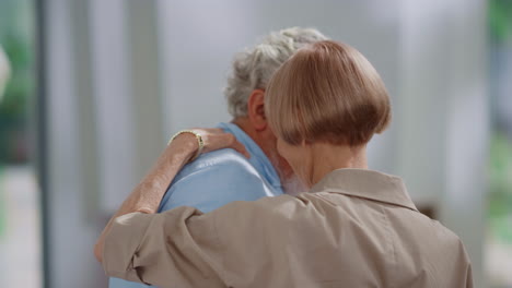 senior man and woman dancing together at home