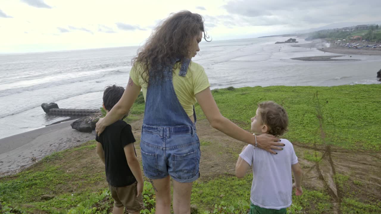 женщина и два мальчика наслаждаются природой.