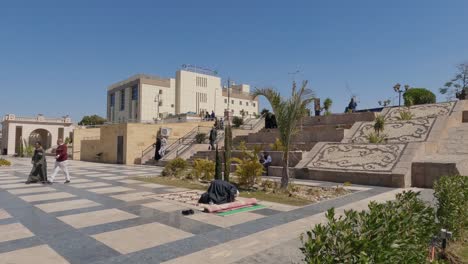 local muslim male egyptian praying outside beside steps in courtyard in luxor egypt