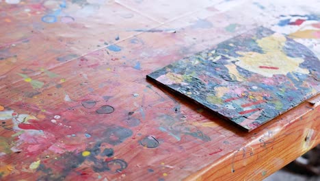 colorful painting process on a wooden desk