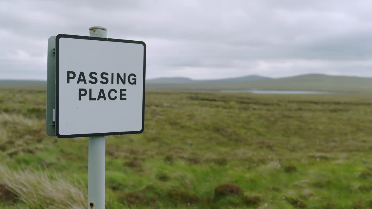 Close up shot of a passing place sign amidst the moorland landscape on Lewis