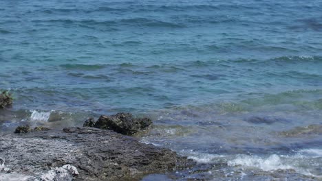 Waves-crushing-on-the-rocks-on-the-beach-in-slow-motion